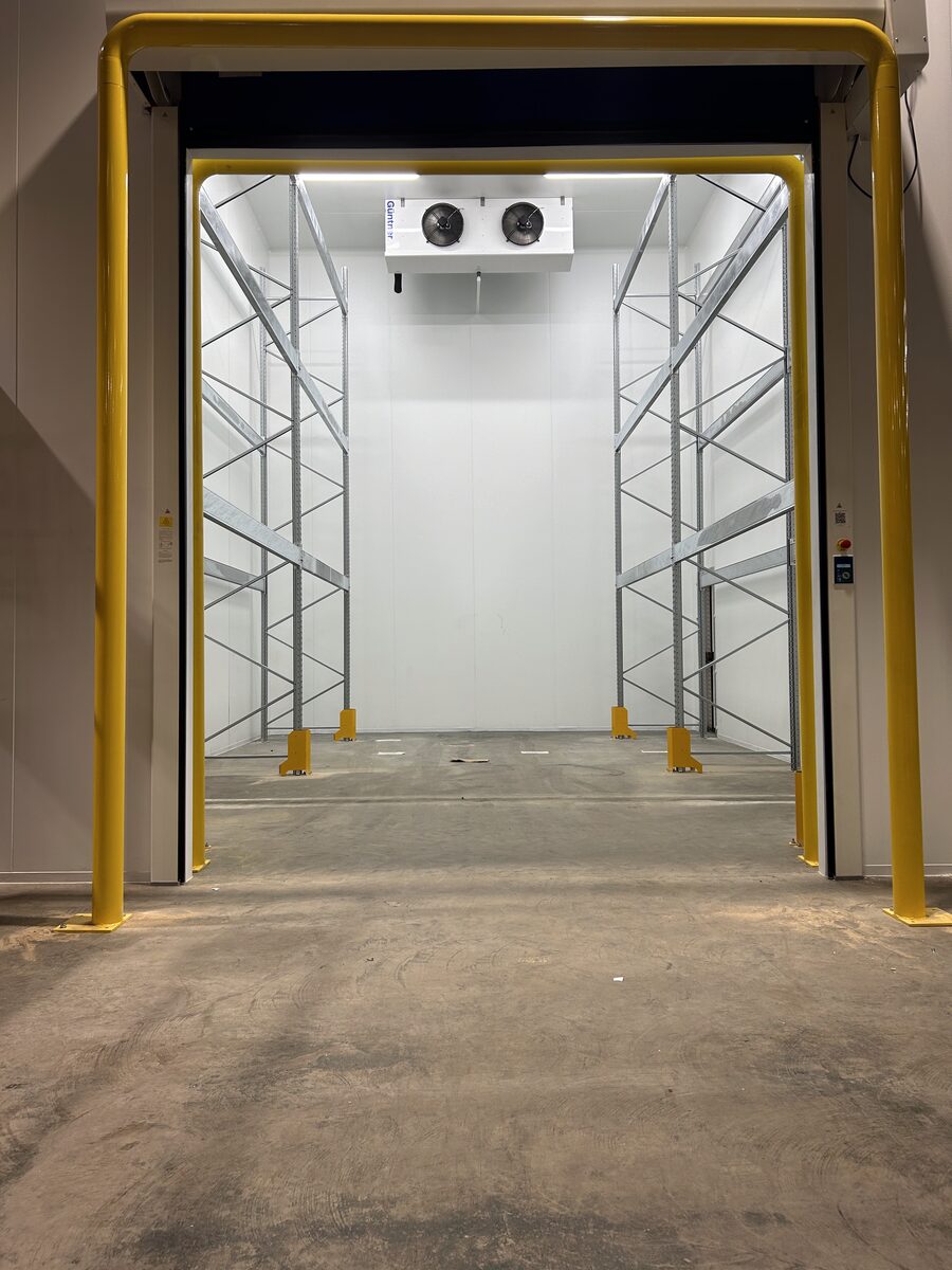 Cold Storage Entrance - Cold room entrance with yellow safety frame and shelving