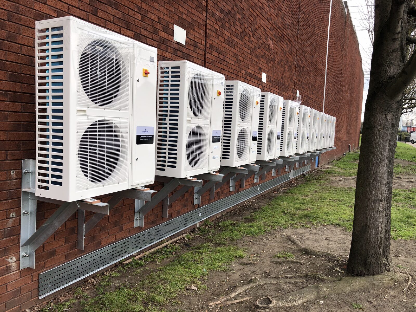 AC Condensing Units - Row of air conditioning condensing units on exterior wall