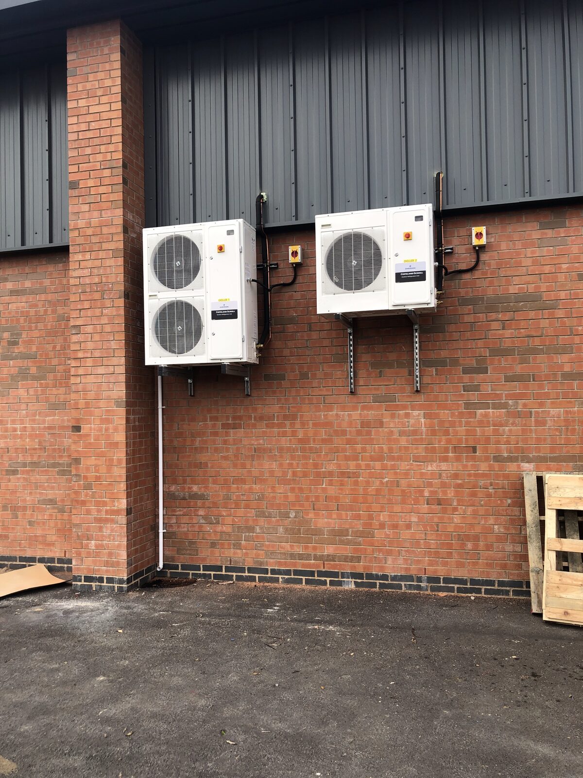 Outdoor Condensing Units - Twin condensing units wall-mounted on commercial building